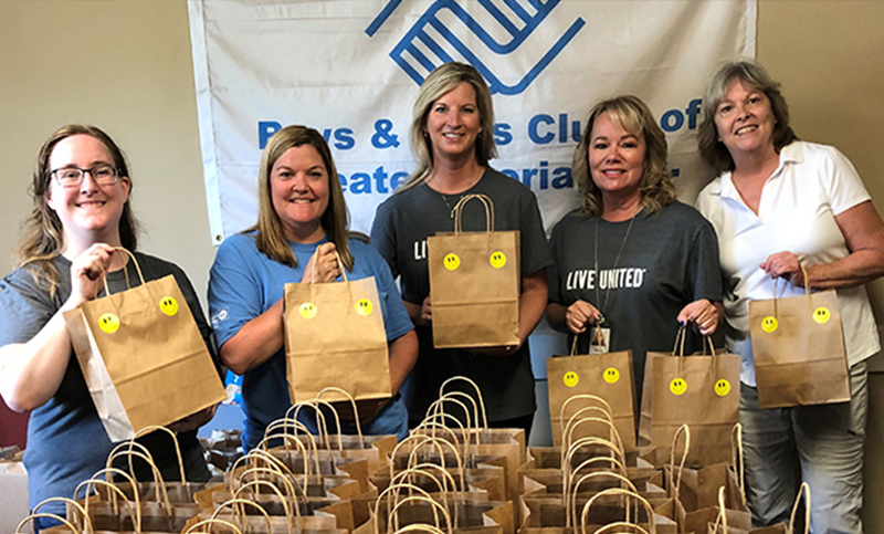Illinois Mutual employees packing bags for the boys and girls club