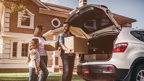 image of a small family packing a car