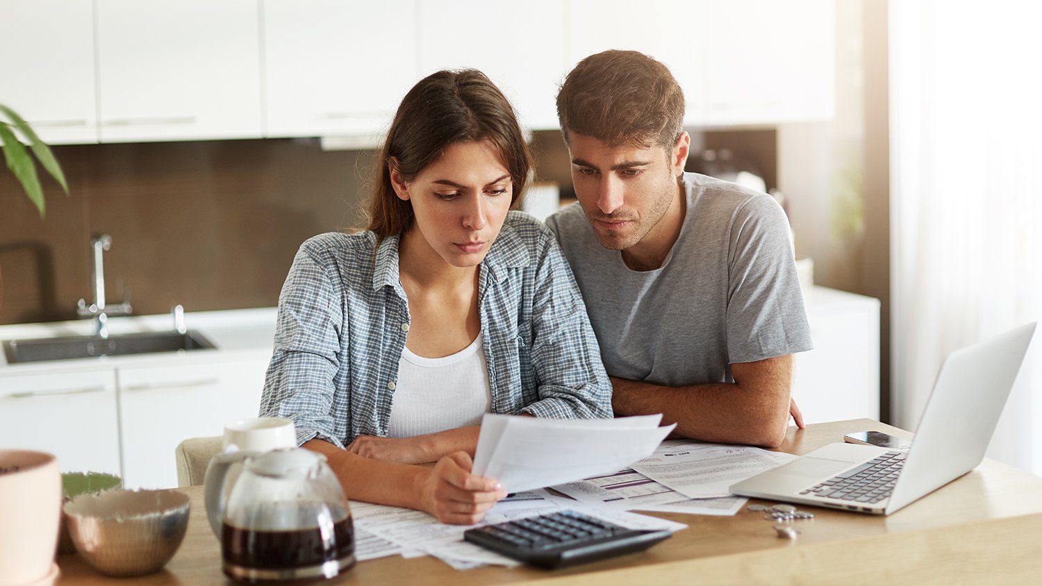 young couple looking over financial paperwork