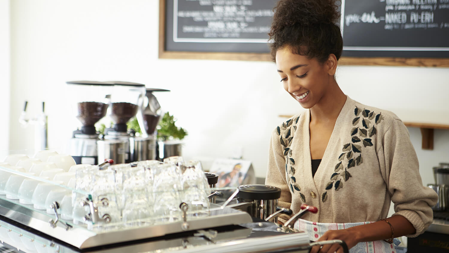 small business owner smiling at her counter