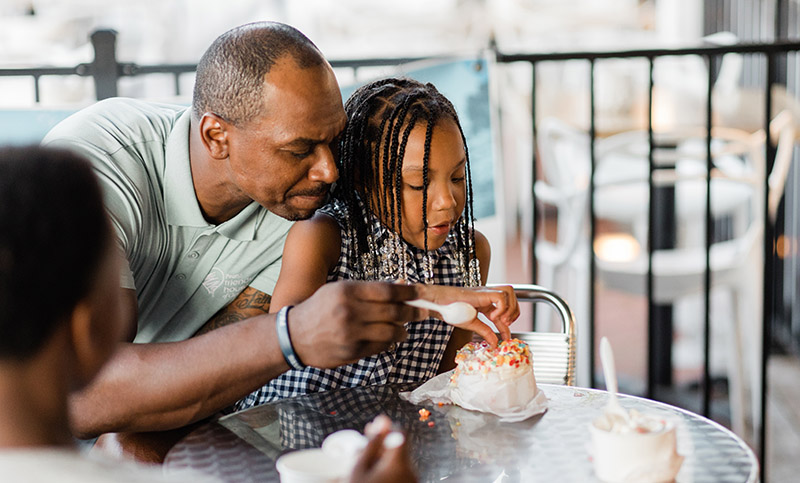 father and daughter enjoying ice cream