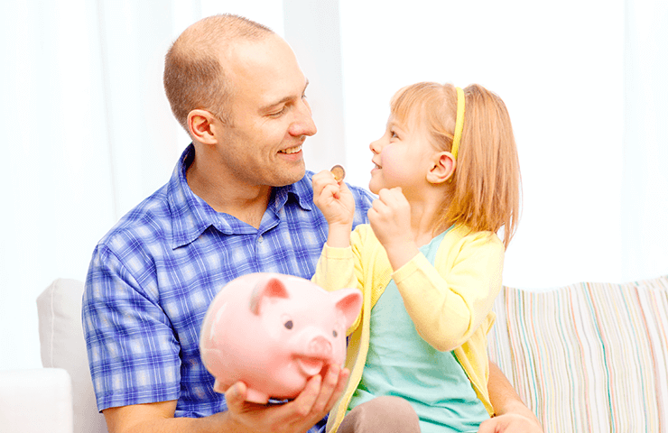 father and daughter holding a piggy bank