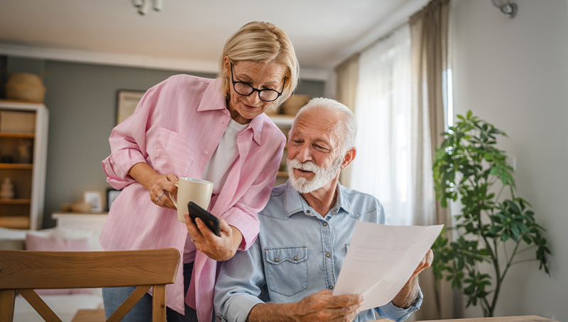 debt-coverage couple looking at doucuments