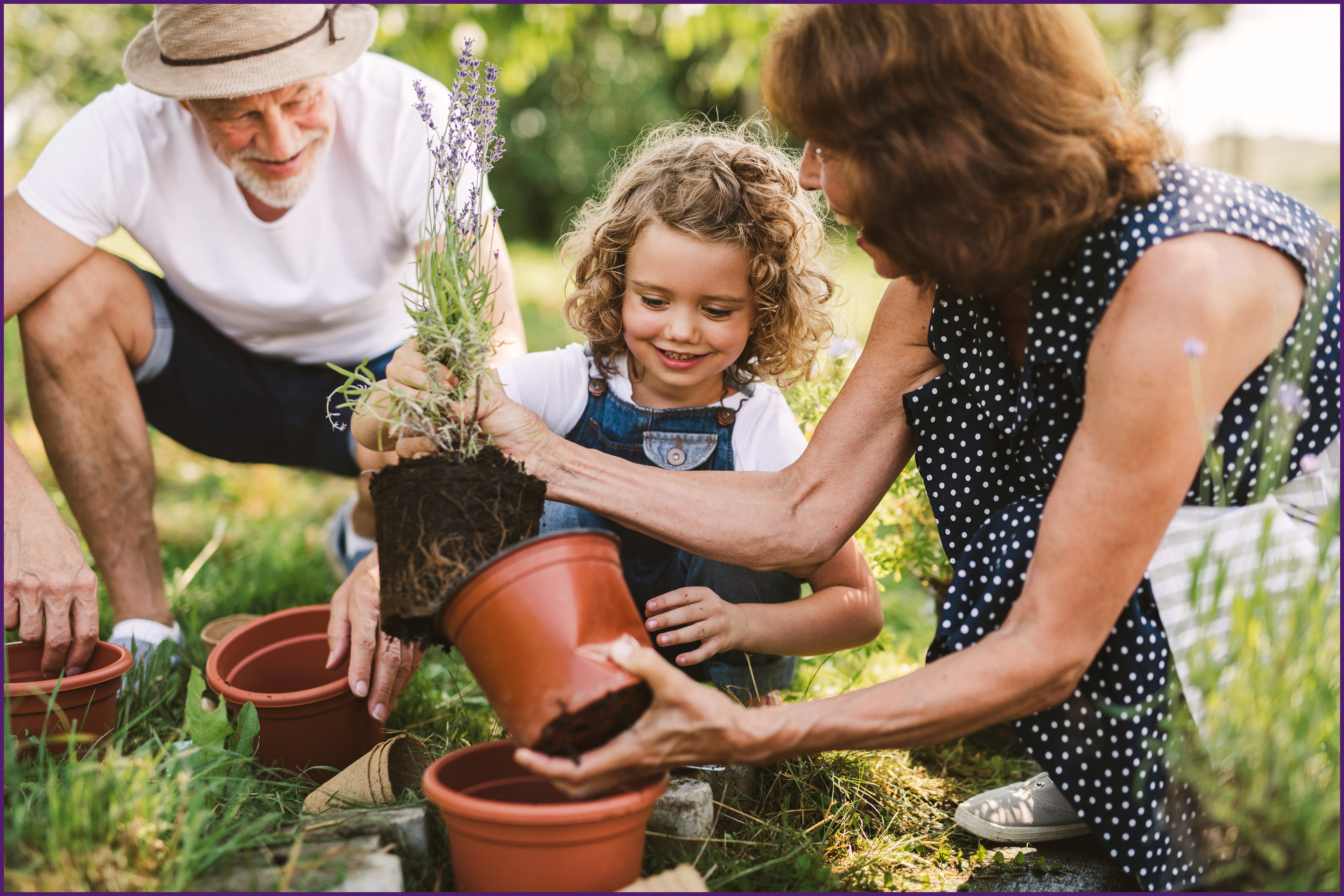 image of a family outside potting plants