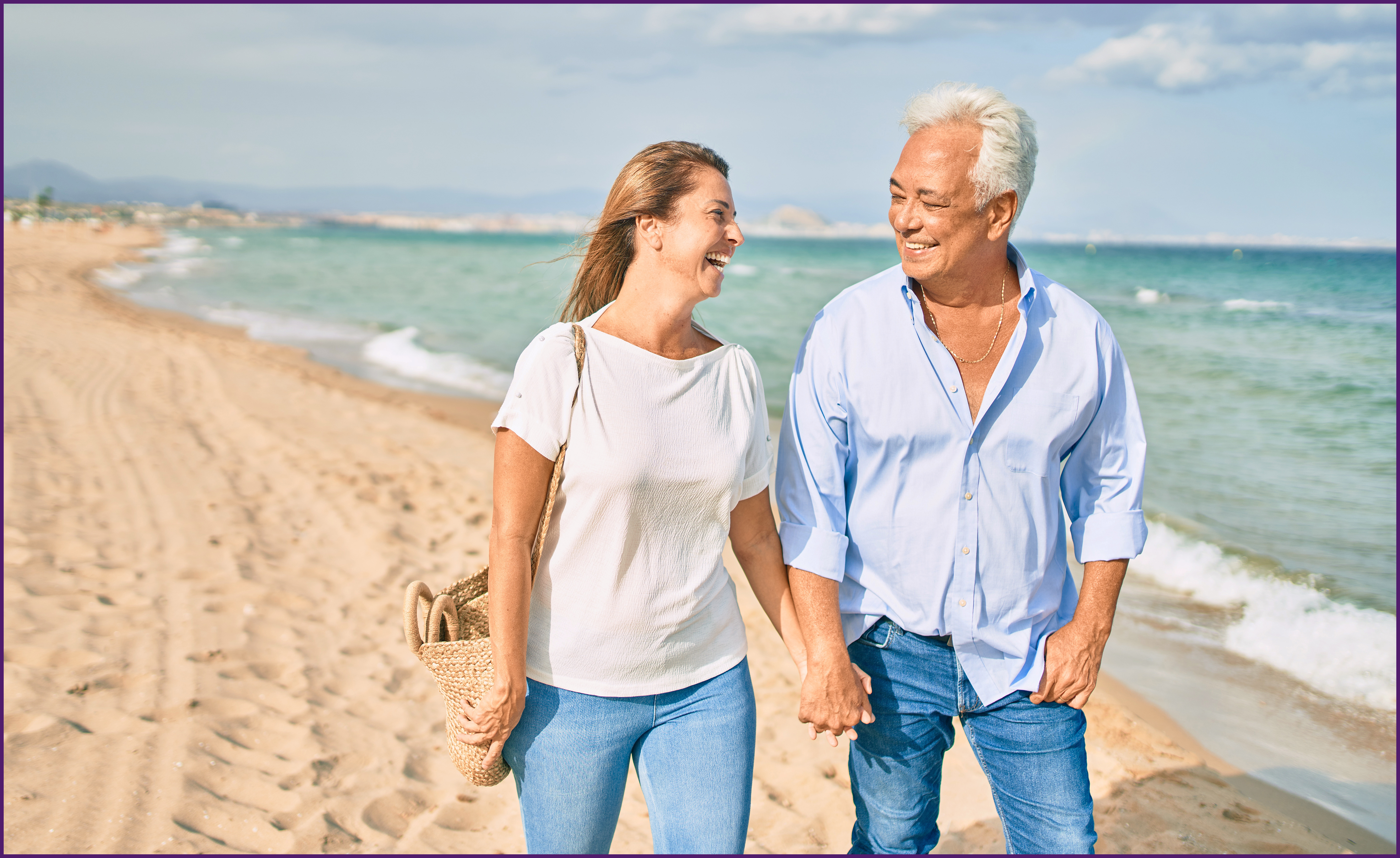 image of a couple walking along the beach
