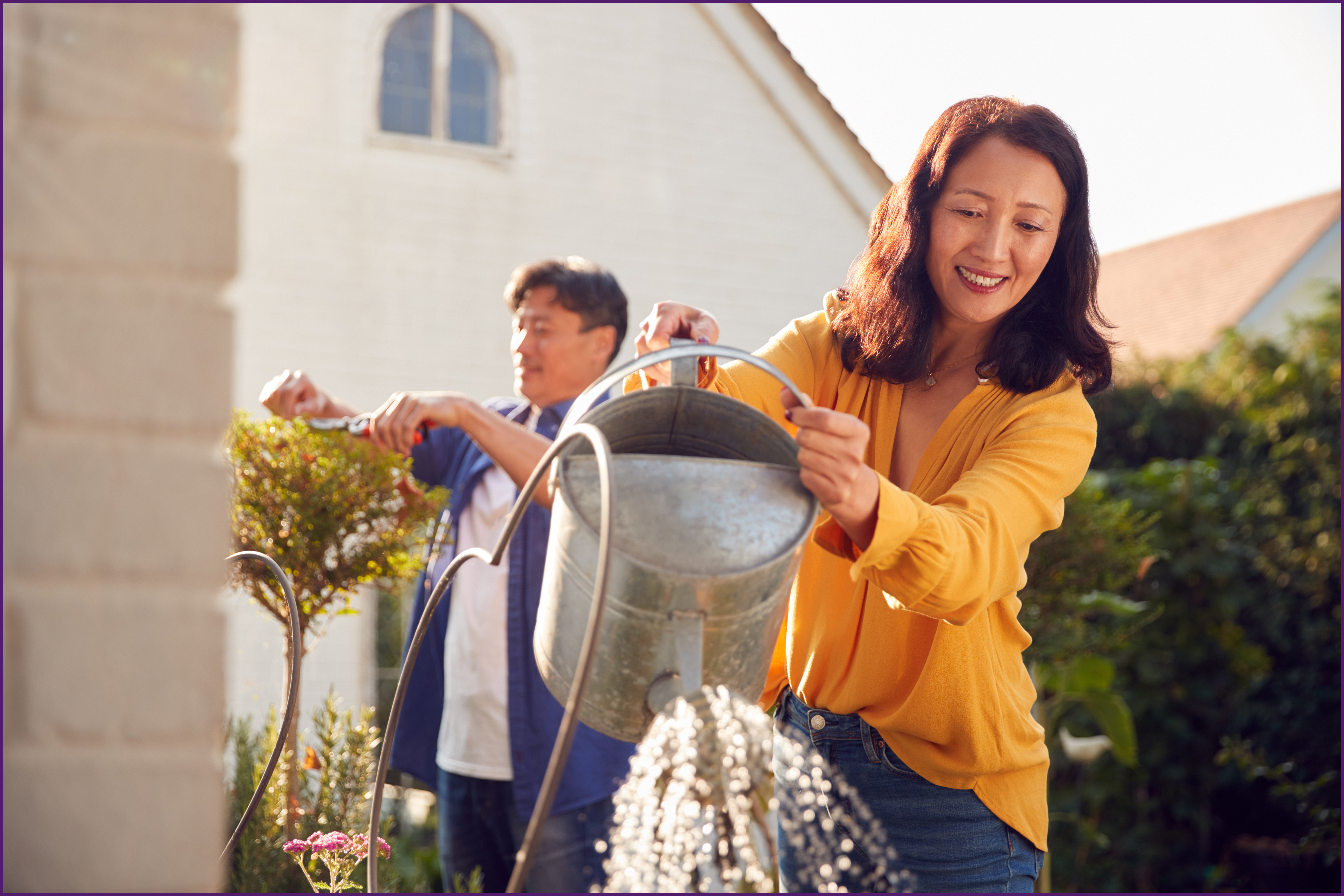 image of a couple outside doing lawncare