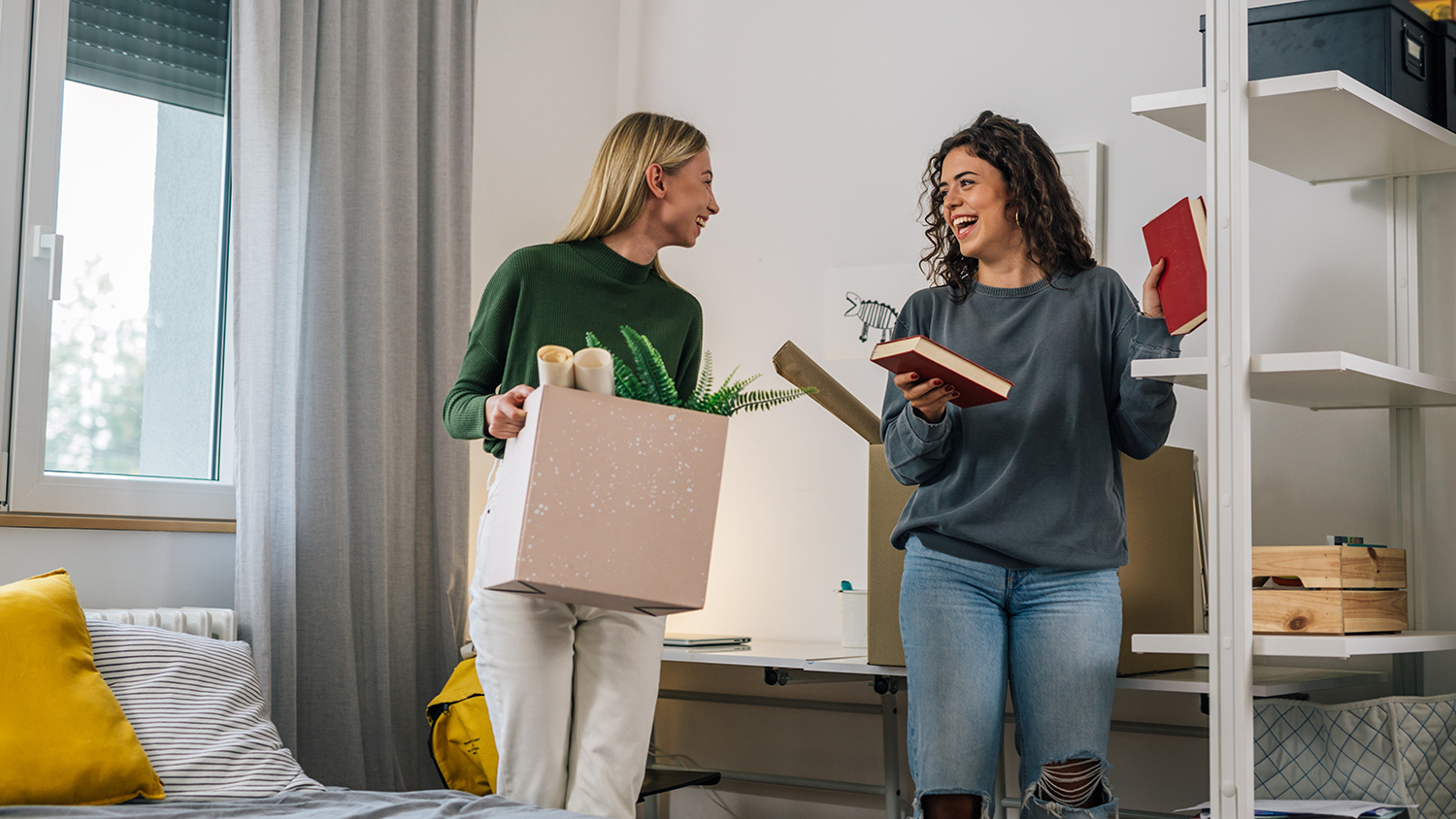 Image of two young girls moving into there dorm room