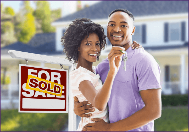 smiling couple in front of new home