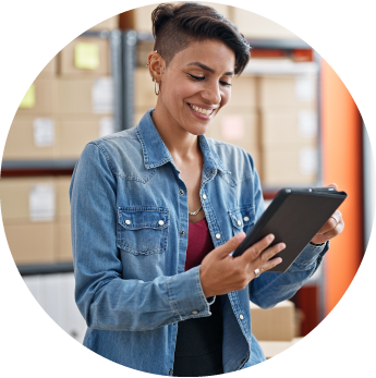 image of a female standing in a warehouse looking at a tablet