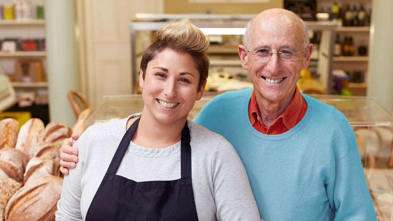 two small business owners smiling