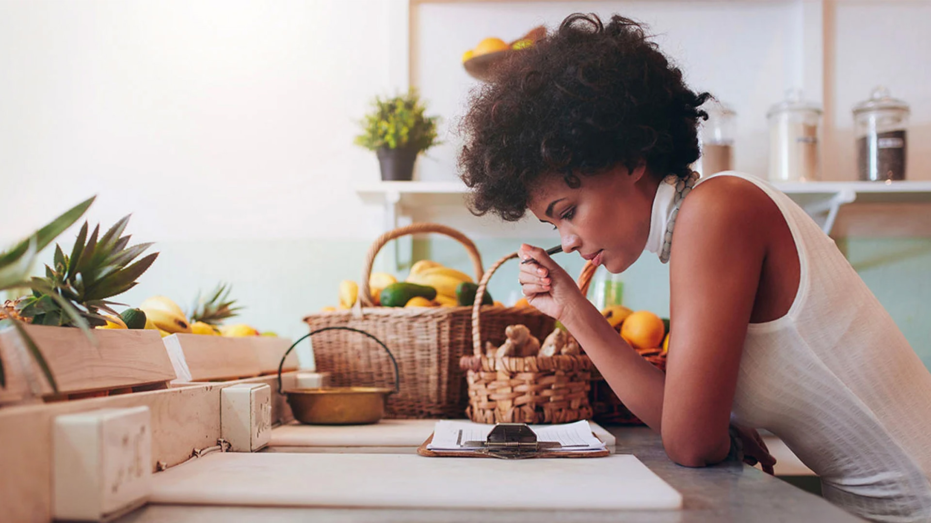 image of a woman in the kitchen standing at the sink